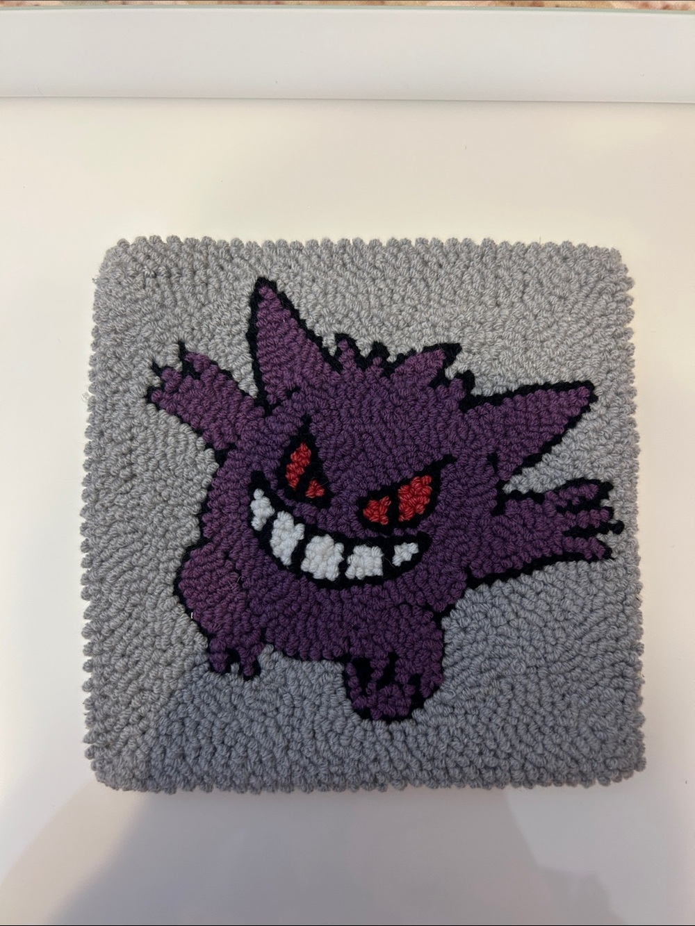 Handmade punch needle coaster with Pokemon inspired character design